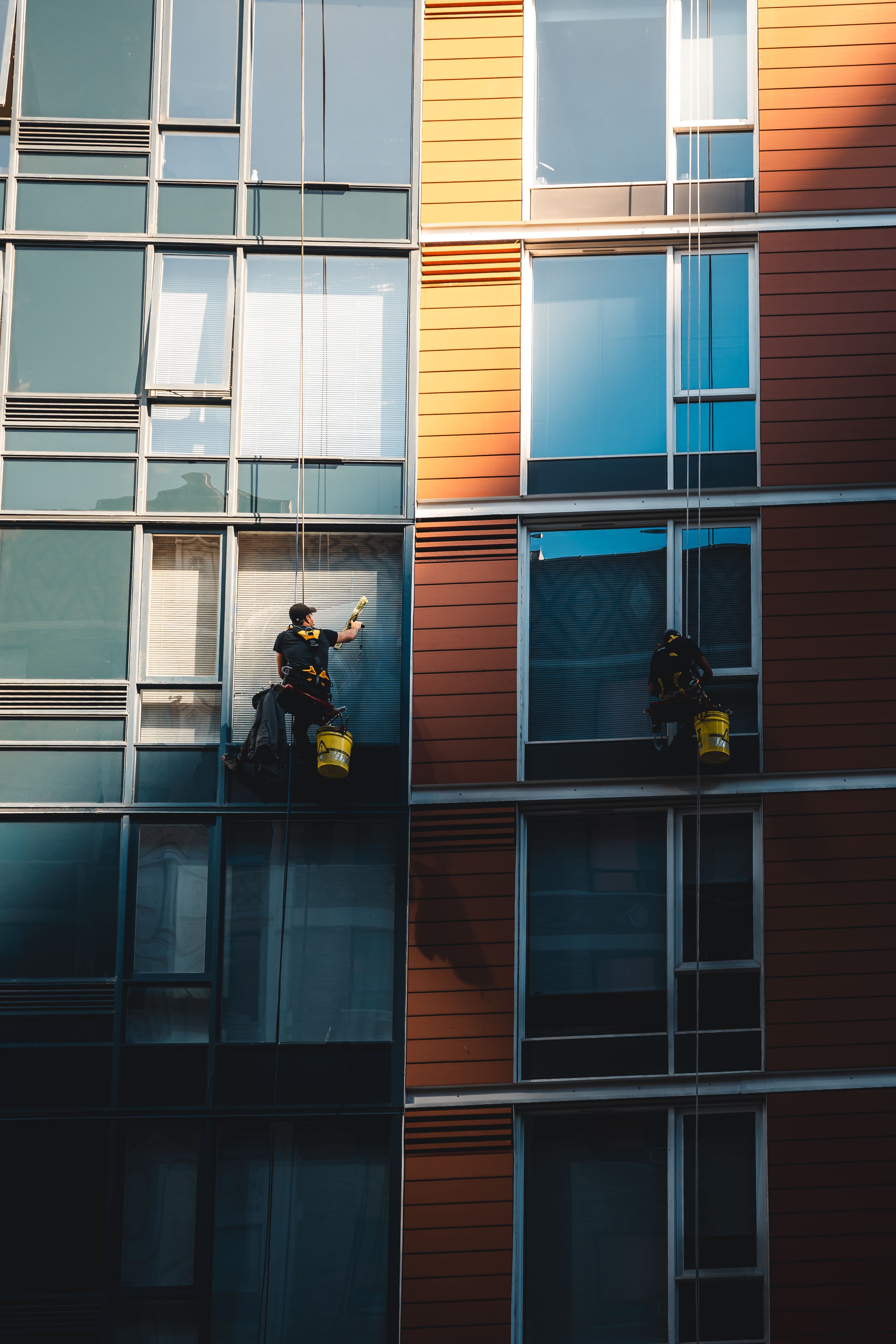 Professional cleaning work near bright building glazing